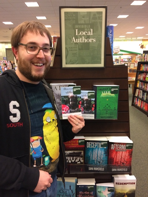 Local Sioux City author Randal Eldon Greene with a copy of his novel Descriptions of Heaven.